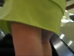 The attractive woman with the green petticoat was unaware. I captured her in an upskirt movie sequence.